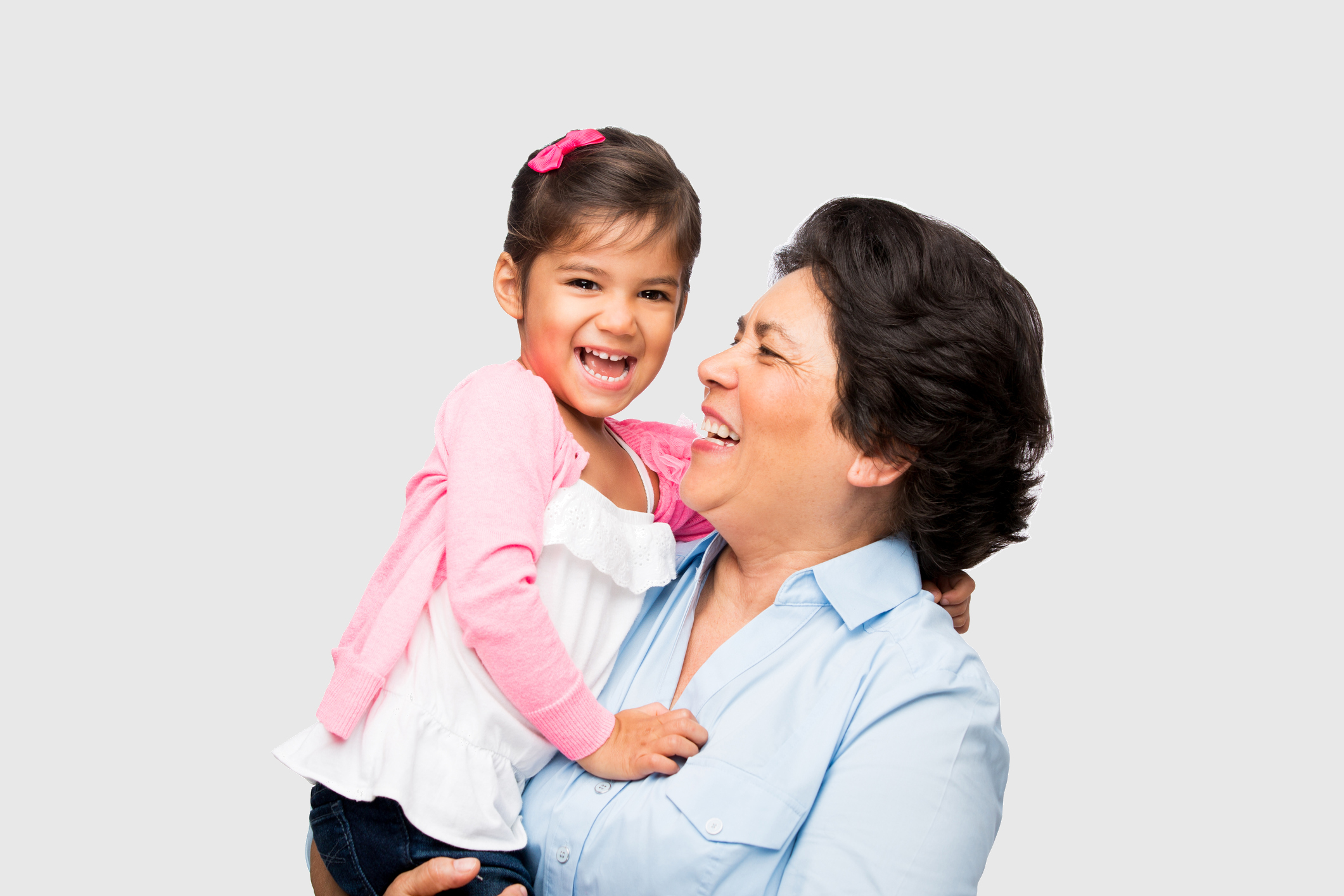 Grandmother holding toddler age grandaughter laughing